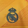 maillotrealmadridexterieurorangelogo.jpg Fodboldtrøje Real Madrid Udebane 2024-2025 stofdetalje
